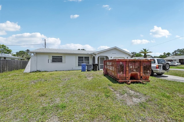 rear view of property featuring stucco siding