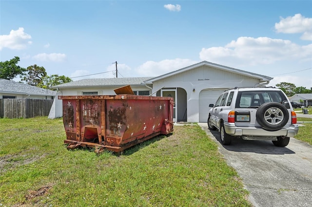 view of home's exterior featuring a garage and asphalt driveway