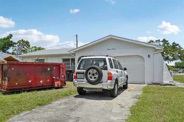 view of home's exterior with driveway, an attached garage, and a lawn