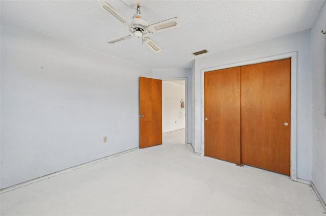 unfurnished bedroom featuring a closet, a ceiling fan, a textured ceiling, and concrete floors