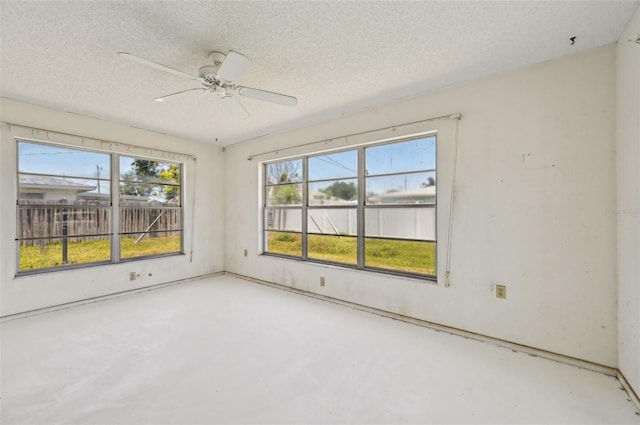 empty room with concrete floors, a textured ceiling, and ceiling fan
