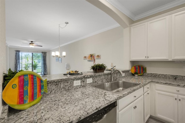 9823 Haze Dr, Venice, FL 34292 - kitchen featuring a sink, a peninsula, white cabinets, arched walkways, and ornamental molding