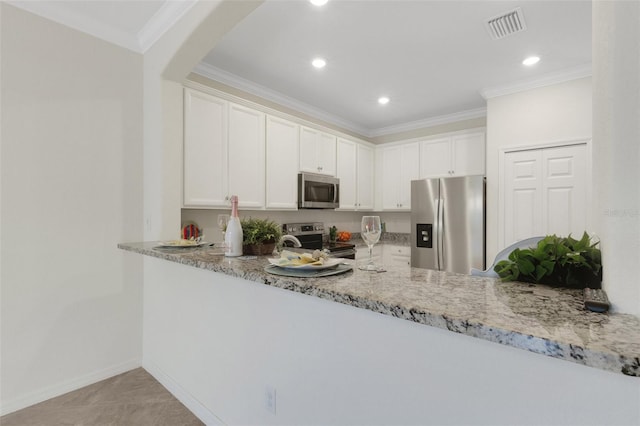 9823 Haze Dr, Venice, FL 34292 - kitchen featuring appliances with stainless steel finishes, light stone counters, a peninsula, white cabinetry, and crown molding
