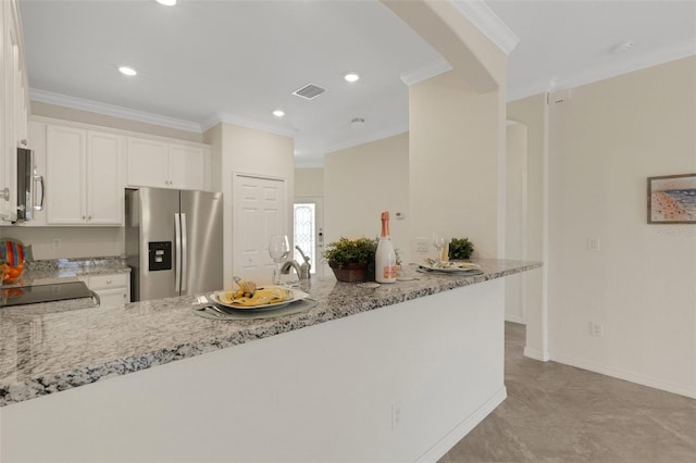 9823 Haze Dr, Venice, FL 34292 - kitchen with stainless steel appliances, ornamental molding, a peninsula, light stone countertops, and white cabinetry