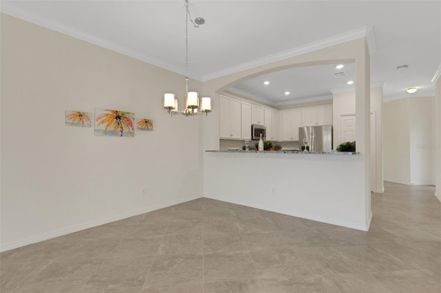 9823 Haze Dr, Venice, FL 34292 - kitchen featuring stainless steel appliances, ornamental molding, a chandelier, arched walkways, and white cabinetry