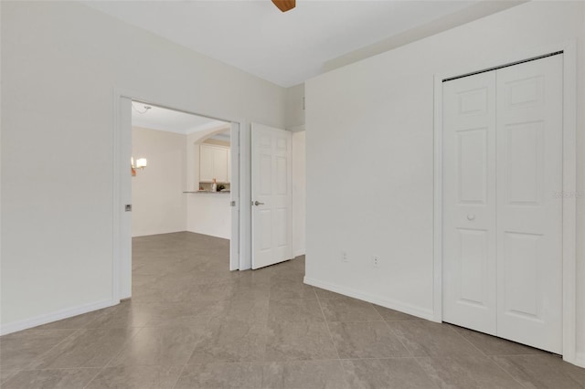9823 Haze Dr, Venice, FL 34292 - unfurnished bedroom featuring a closet, tile patterned floors, baseboards, and a ceiling fan