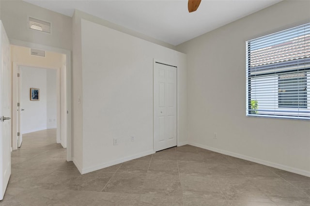 9823 Haze Dr, Venice, FL 34292 - spare room with a ceiling fan, baseboards, and light tile patterned floors