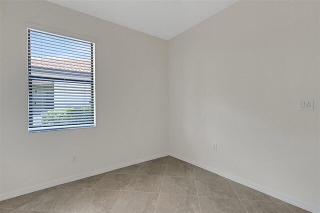 9823 Haze Dr, Venice, FL 34292 - empty room with tile patterned flooring and baseboards