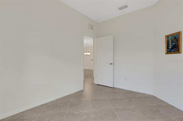 9823 Haze Dr, Venice, FL 34292 - spare room with light tile patterned floors, baseboards, and a chandelier