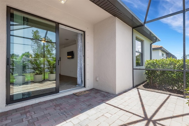 9823 Haze Dr, Venice, FL 34292 - property entrance featuring stucco siding and a patio area