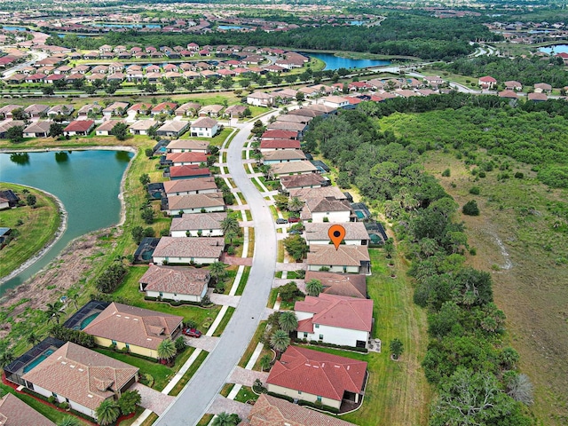view of property location with a large body of water and nearby suburban area