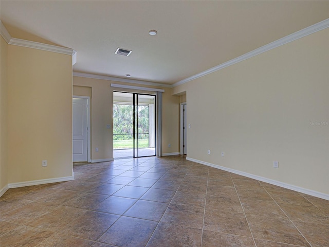 spare room with ornamental molding and baseboards