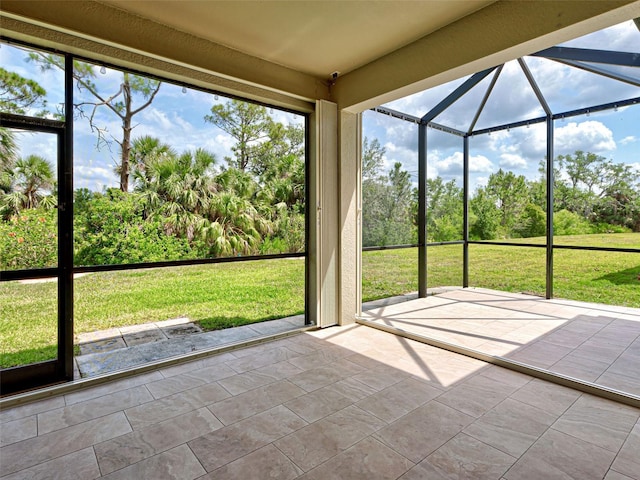 unfurnished sunroom with view of scattered trees