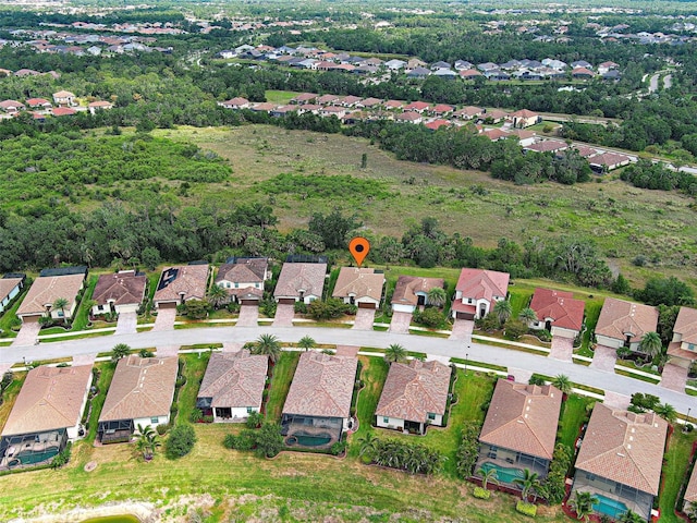aerial view of property and surrounding area featuring nearby suburban area
