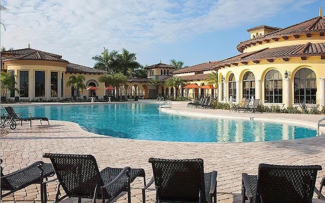 community pool featuring a patio area
