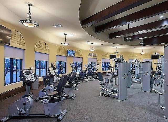 gym featuring beam ceiling