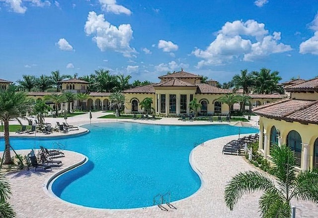 community pool with a patio area