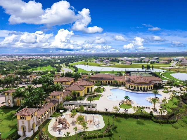 aerial view of residential area with a large body of water and a pool