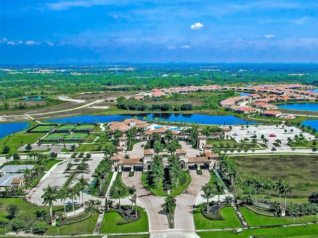 aerial view of property and surrounding area with a nearby body of water and nearby suburban area