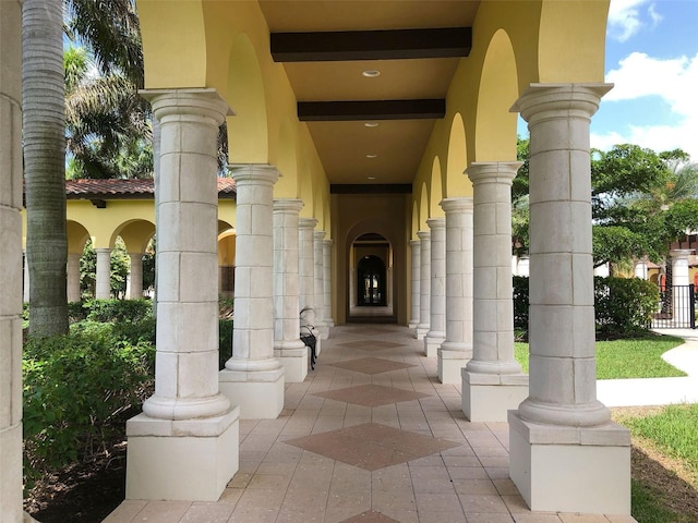 doorway to property with stucco siding and covered porch