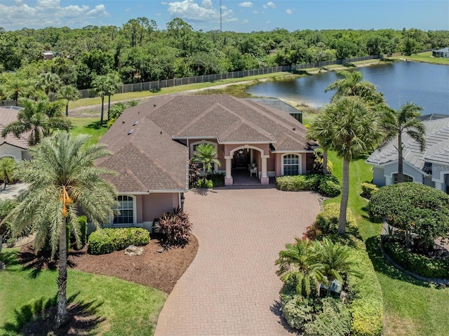 148 Wading Bird Dr, Venice, FL 34292 - view of front of home featuring decorative driveway, a water view, stucco siding, and a shingled roof