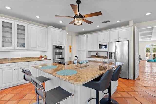63 Palm Dr, Placida, FL 33946 - kitchen featuring appliances with stainless steel finishes, recessed lighting, white cabinets, ceiling fan, and glass insert cabinets