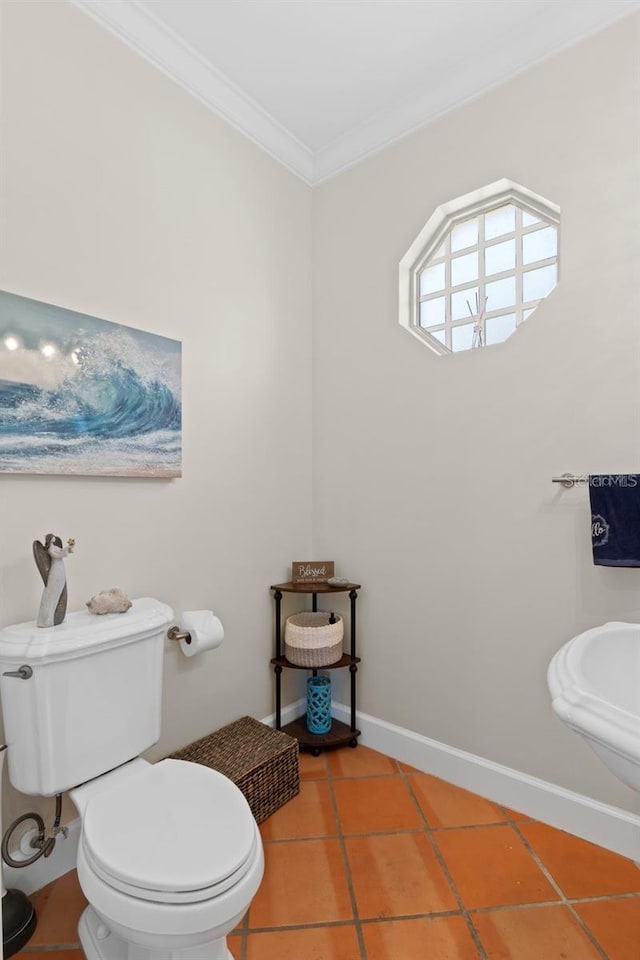 63 Palm Dr, Placida, FL 33946 - half bathroom featuring crown molding, tile patterned floors, toilet, and baseboards