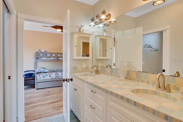 63 Palm Dr, Placida, FL 33946 - bathroom featuring ensuite bathroom, wood finished floors, double vanity, and ornamental molding