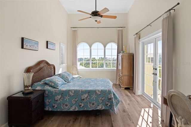 63 Palm Dr, Placida, FL 33946 - bedroom featuring access to outside, crown molding, wood finished floors, french doors, and baseboards