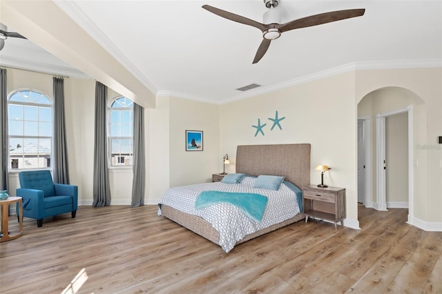 63 Palm Dr, Placida, FL 33946 - bedroom featuring arched walkways, wood finished floors, crown molding, and baseboards