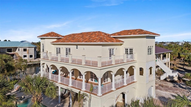 63 Palm Dr, Placida, FL 33946 - rear view of house featuring a balcony and stucco siding