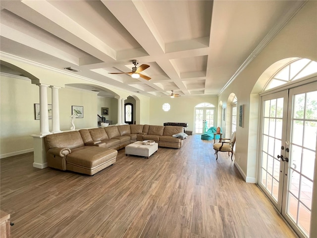 63 Palm Dr, Placida, FL 33946 - living room featuring french doors, coffered ceiling, arched walkways, wood finished floors, and baseboards