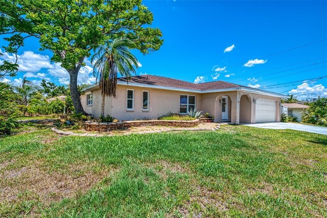 4321 Shamrock Dr, Venice, FL 34293 - ranch-style home featuring stucco siding, a garage, driveway, and a front lawn