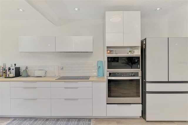 4321 Shamrock Dr, Venice, FL 34293 - kitchen with stainless steel oven, freestanding refrigerator, modern cabinets, black electric stovetop, and recessed lighting