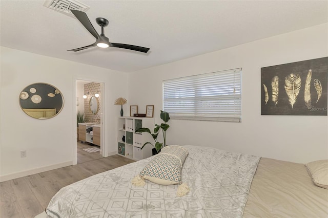 4321 Shamrock Dr, Venice, FL 34293 - bedroom with wood finished floors, a ceiling fan, connected bathroom, and baseboards