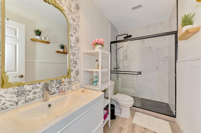 4321 Shamrock Dr, Venice, FL 34293 - bathroom with a marble finish shower, toilet, wood finished floors, wainscoting, and vanity