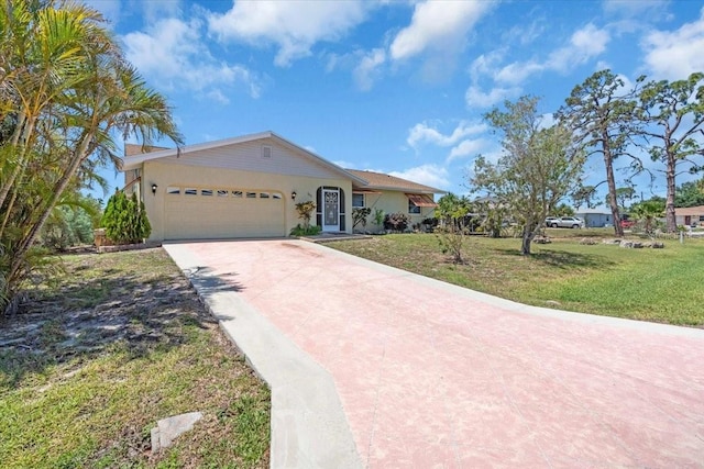 2618 Titania Rd, Englewood, FL 34224 - single story home featuring driveway, a garage, a front yard, and stucco siding