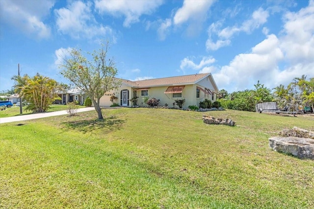2618 Titania Rd, Englewood, FL 34224 - ranch-style home with concrete driveway, a front lawn, stucco siding, and an attached garage