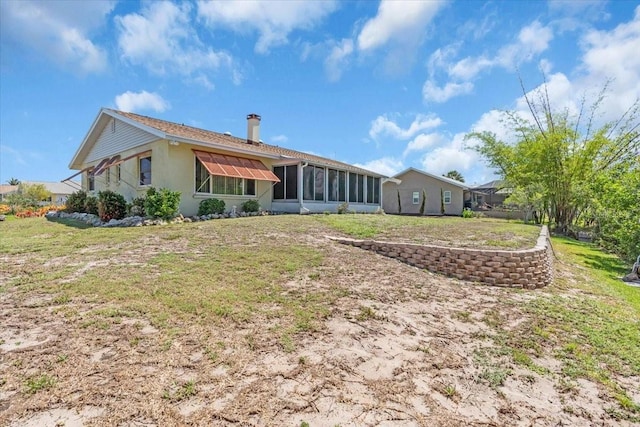 2618 Titania Rd, Englewood, FL 34224 - rear view of property with a lawn and a sunroom