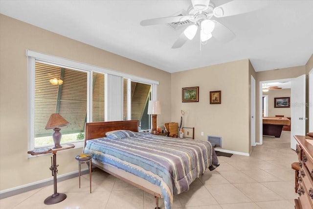 2618 Titania Rd, Englewood, FL 34224 - bedroom featuring baseboards, light tile patterned flooring, and a ceiling fan