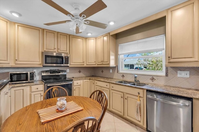 2618 Titania Rd, Englewood, FL 34224 - kitchen with stainless steel appliances, a sink, ceiling fan, light stone counters, and recessed lighting