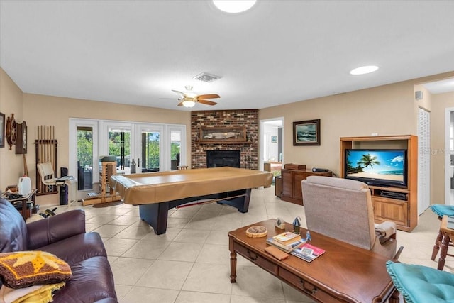2618 Titania Rd, Englewood, FL 34224 - recreation room featuring french doors, a ceiling fan, a brick fireplace, and light tile patterned floors