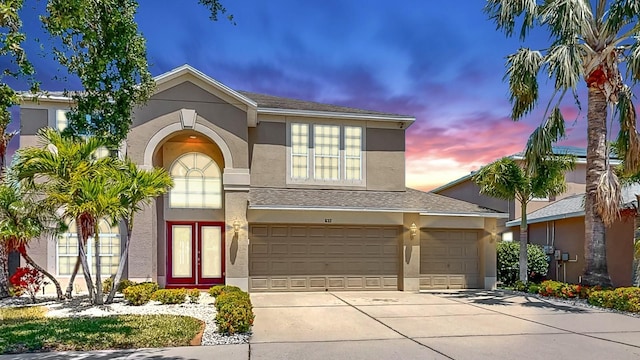 632 Tanana Fall Dr, Ruskin, FL 33570 - traditional-style home with stucco siding, concrete driveway, a garage, and roof with shingles