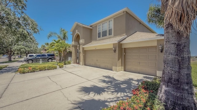 632 Tanana Fall Dr, Ruskin, FL 33570 - view of front of property featuring stucco siding, concrete driveway, roof with shingles, and an attached garage