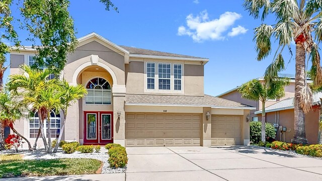 632 Tanana Fall Dr, Ruskin, FL 33570 - traditional home featuring stucco siding, concrete driveway, and an attached garage