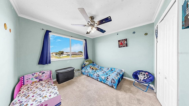 632 Tanana Fall Dr, Ruskin, FL 33570 - carpeted bedroom with a textured ceiling, ornamental molding, baseboards, a closet, and ceiling fan