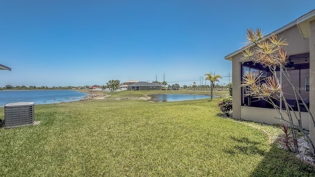 632 Tanana Fall Dr, Ruskin, FL 33570 - view of green lawn featuring central air condition unit and a water view