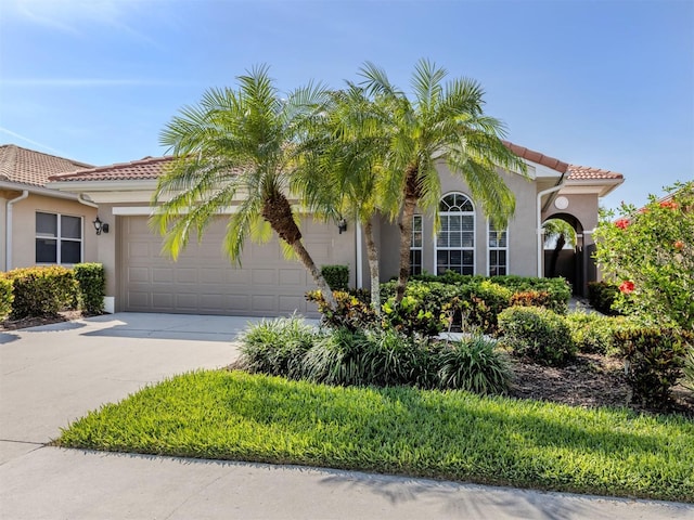 165 Tiziano Way N, Venice, FL 34275 - mediterranean / spanish home with a garage, a tile roof, driveway, and stucco siding