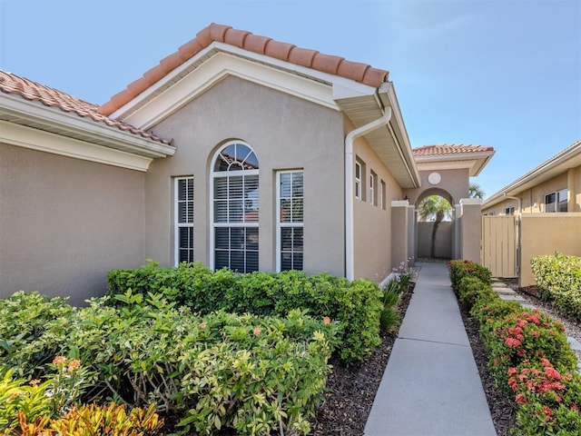 165 Tiziano Way N, Venice, FL 34275 - property entrance with a tile roof and stucco siding