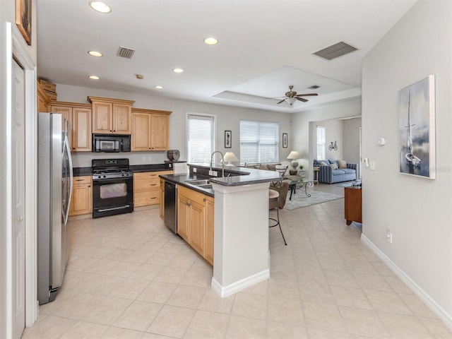 165 Tiziano Way N, Venice, FL 34275 - kitchen with black appliances, a sink, dark countertops, recessed lighting, and open floor plan